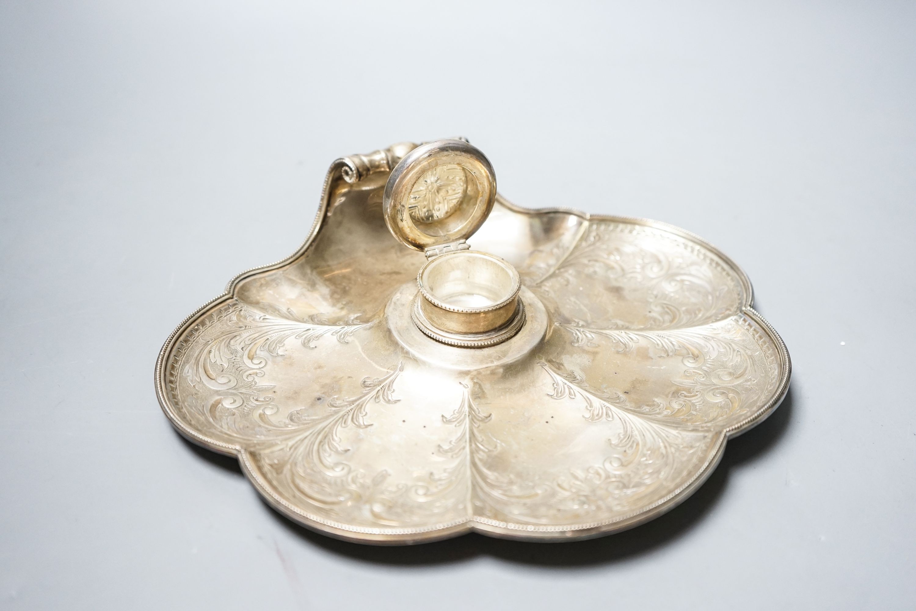 A late Victorian engraved silver shell shaped inkstand with single well, by Walker & Hall, Sheffield, 1897, 23.8cm, gross 14.5oz.